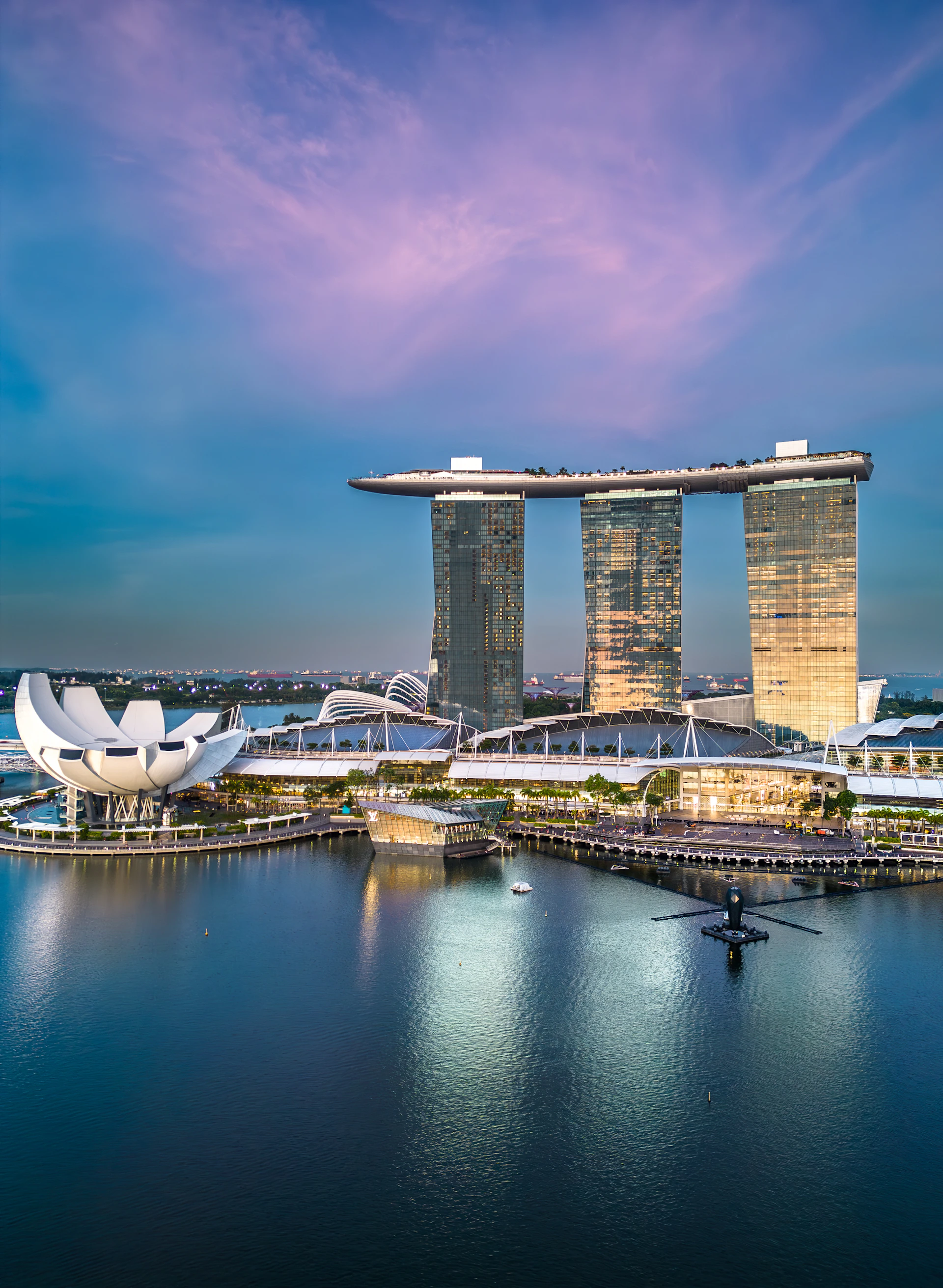 a large body of water with a bunch of tall buildings in the background