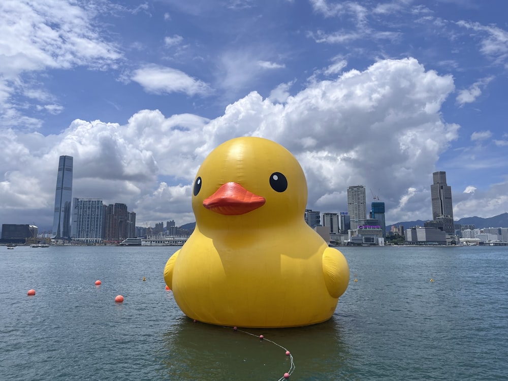 a large yellow rubber duck floating on top of a body of water