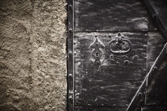 Close-up of a custom metal door with industrial-style handles and welding details.