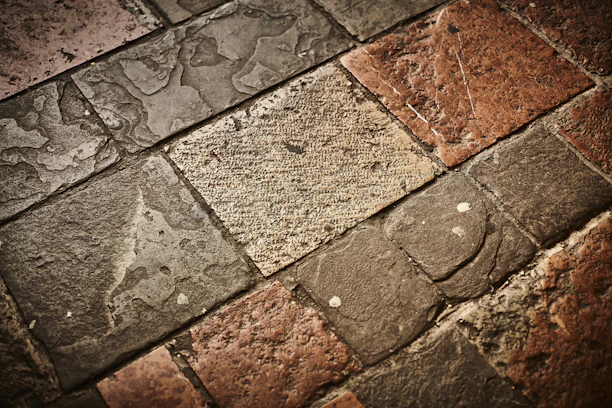 Various stone tiles displayed on a wooden surface showcasing texture and color variations