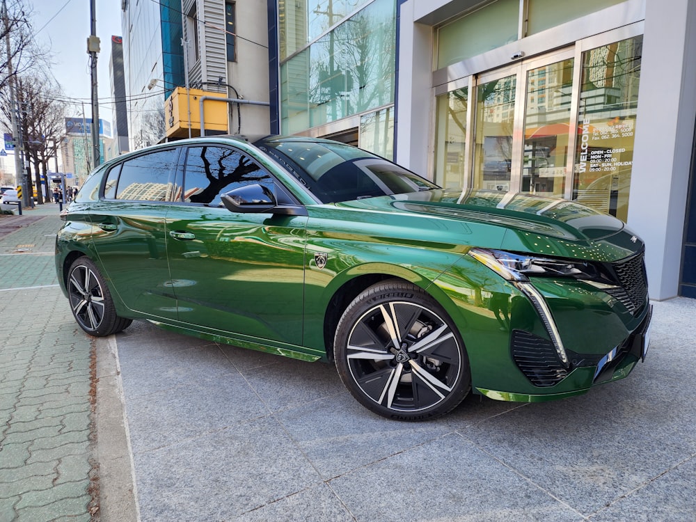 a green car parked in front of a building