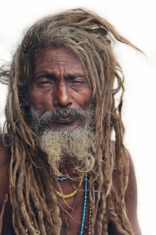 Elegant dreadlocks styled with colorful beads and fresh shine, captured outdoors.