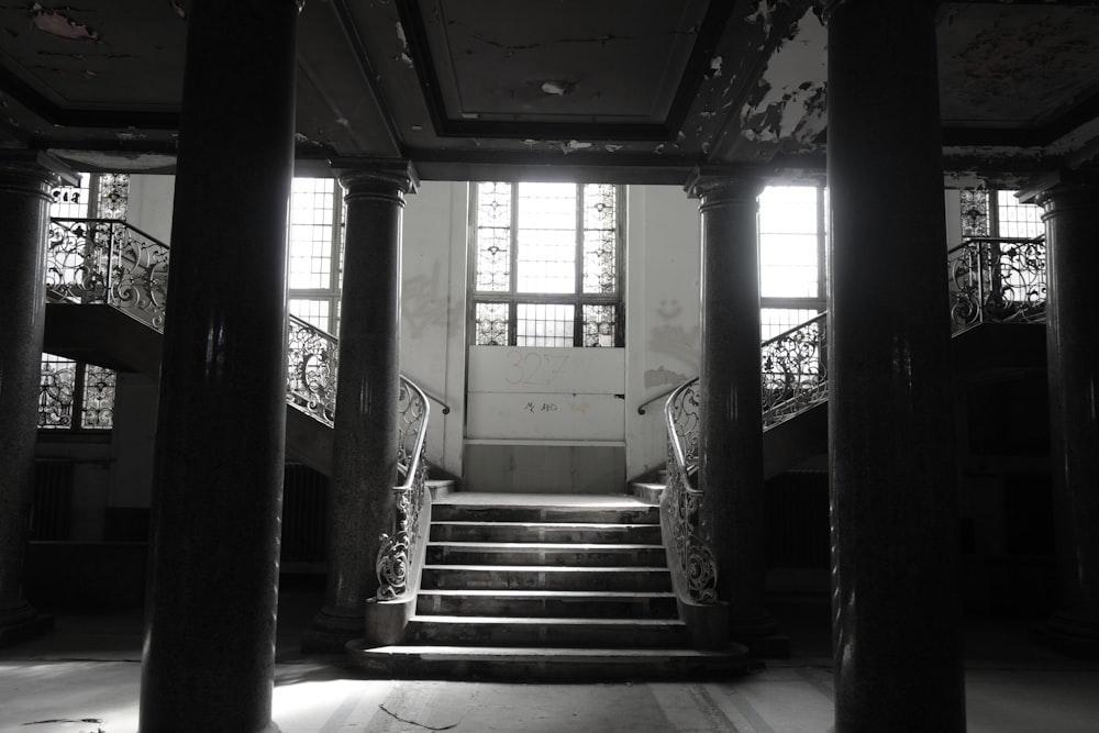 a black and white photo of some stairs and windows
