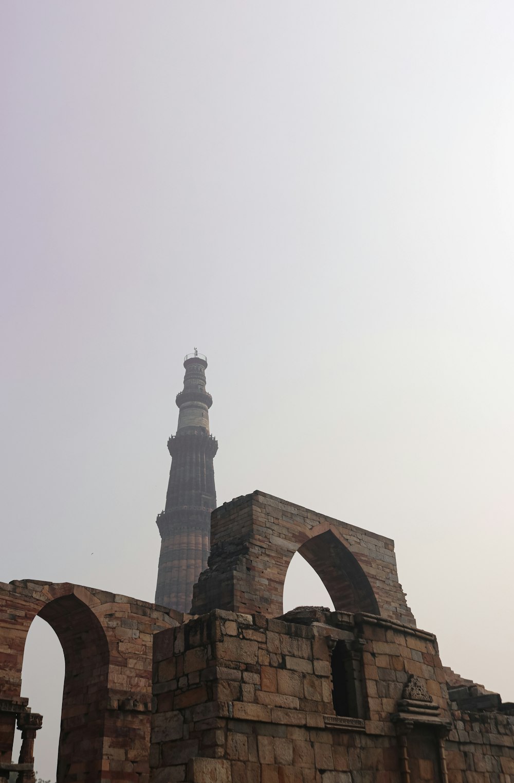 an old brick building with a tower in the background