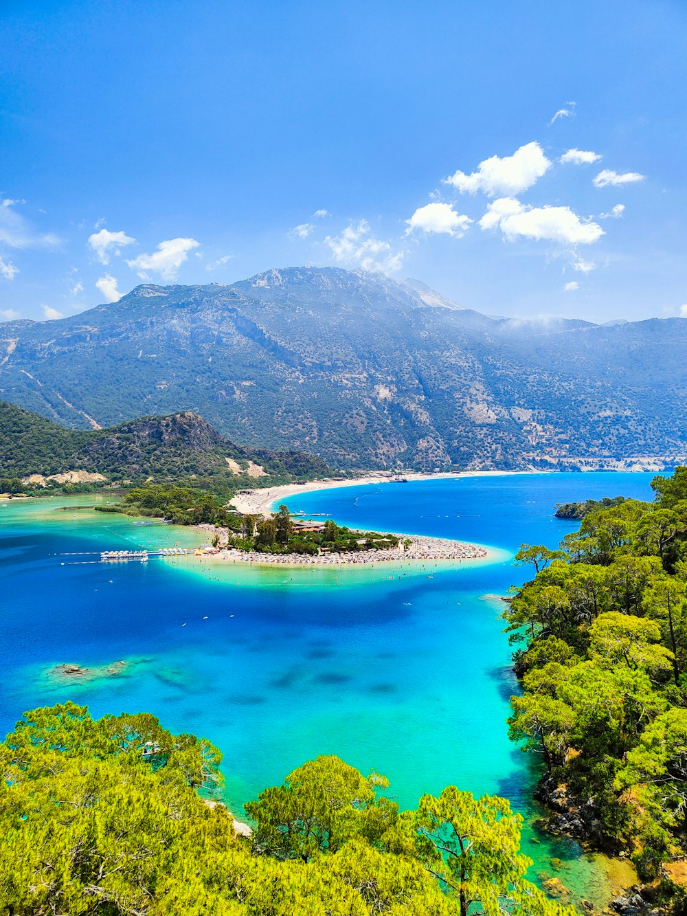 a beautiful blue lake surrounded by trees and mountains