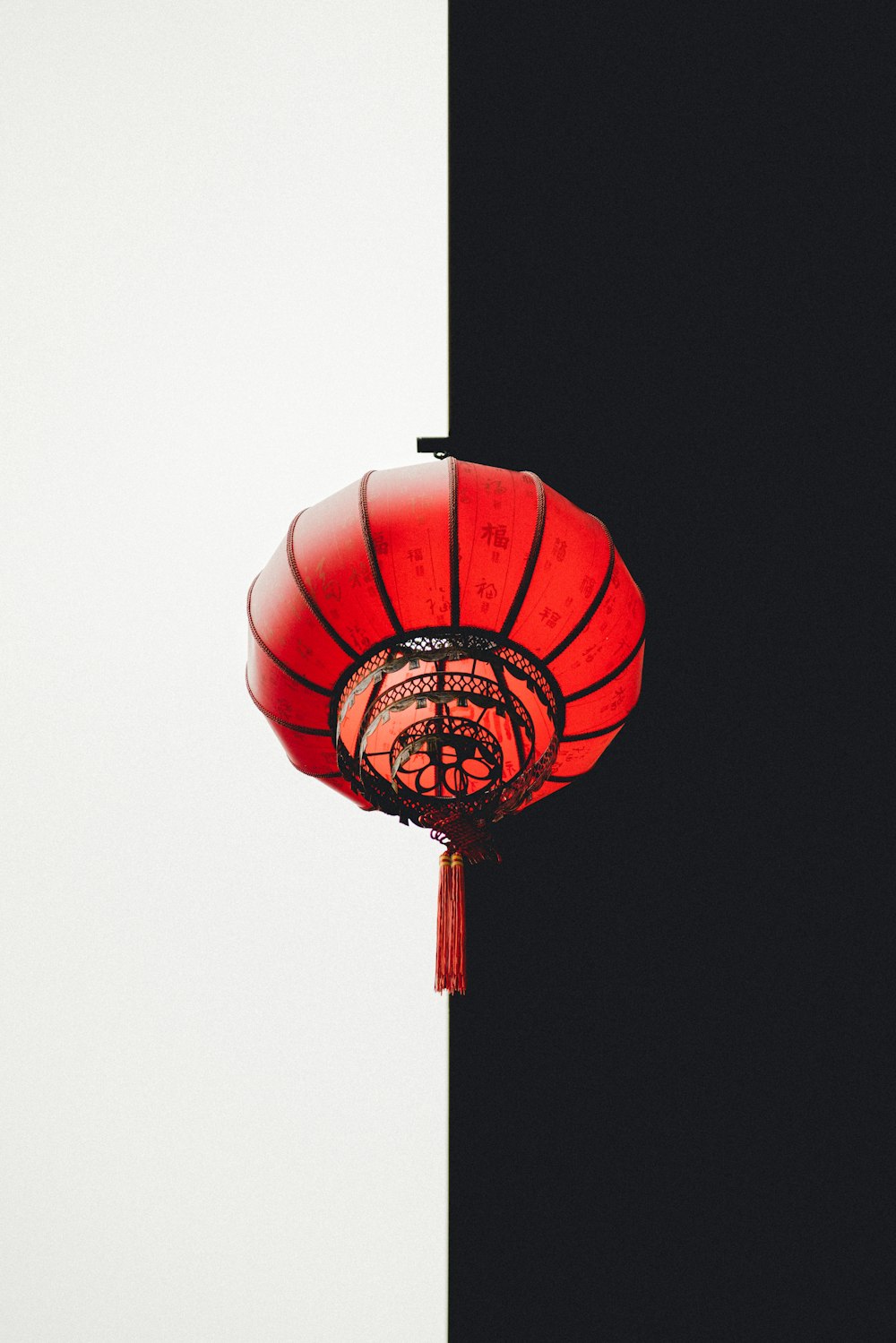 a red lantern hanging from the side of a building