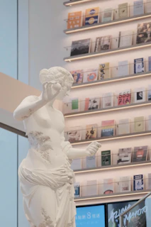 Elegant office interior with legal books and a subtle statue of the goddess of justice on the desk.