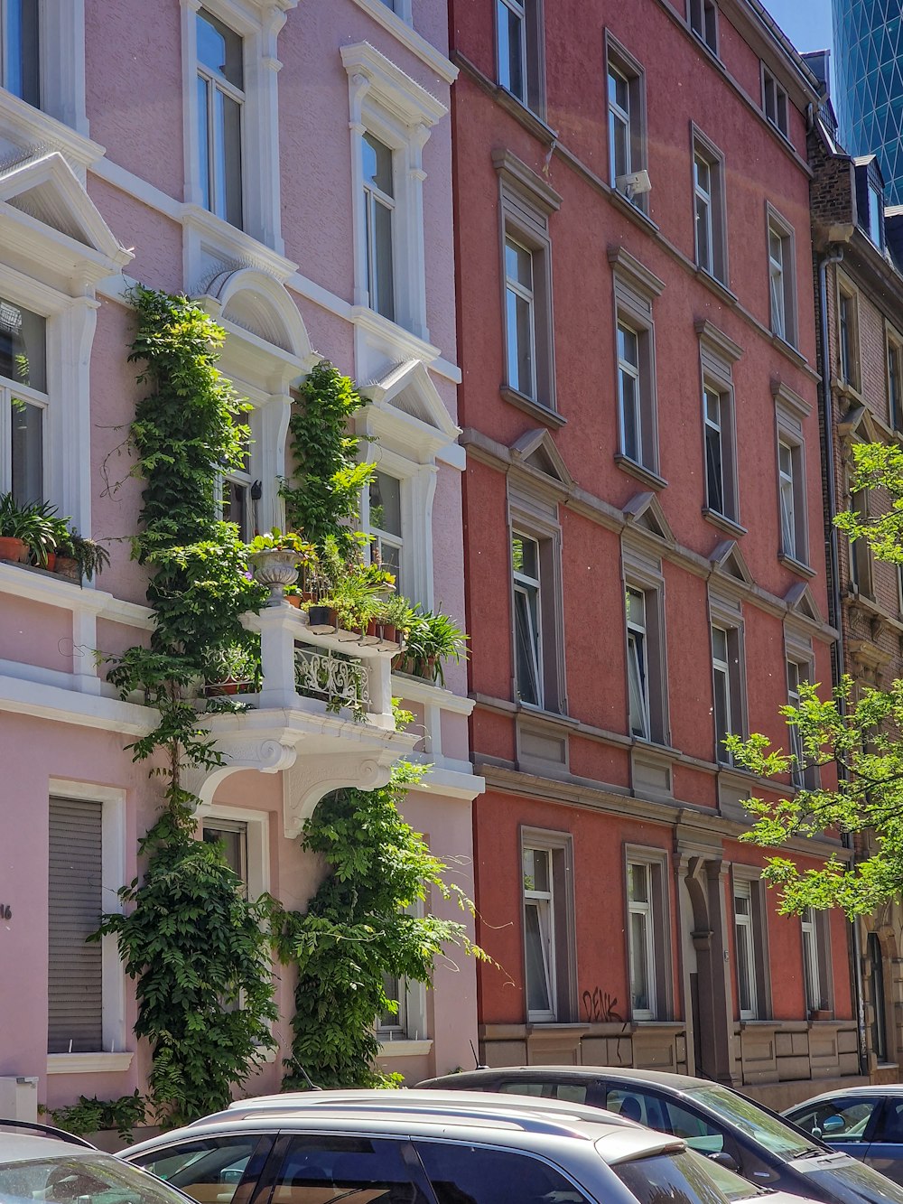 a row of buildings with cars parked in front of them