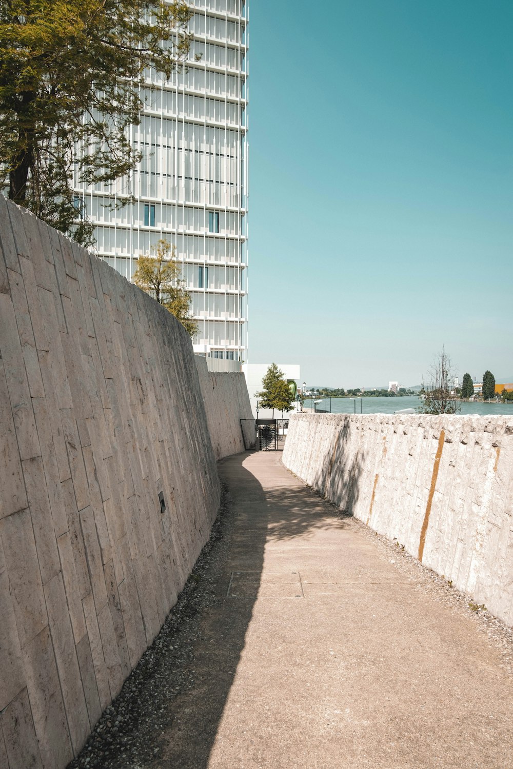 a long stone wall next to a tall building