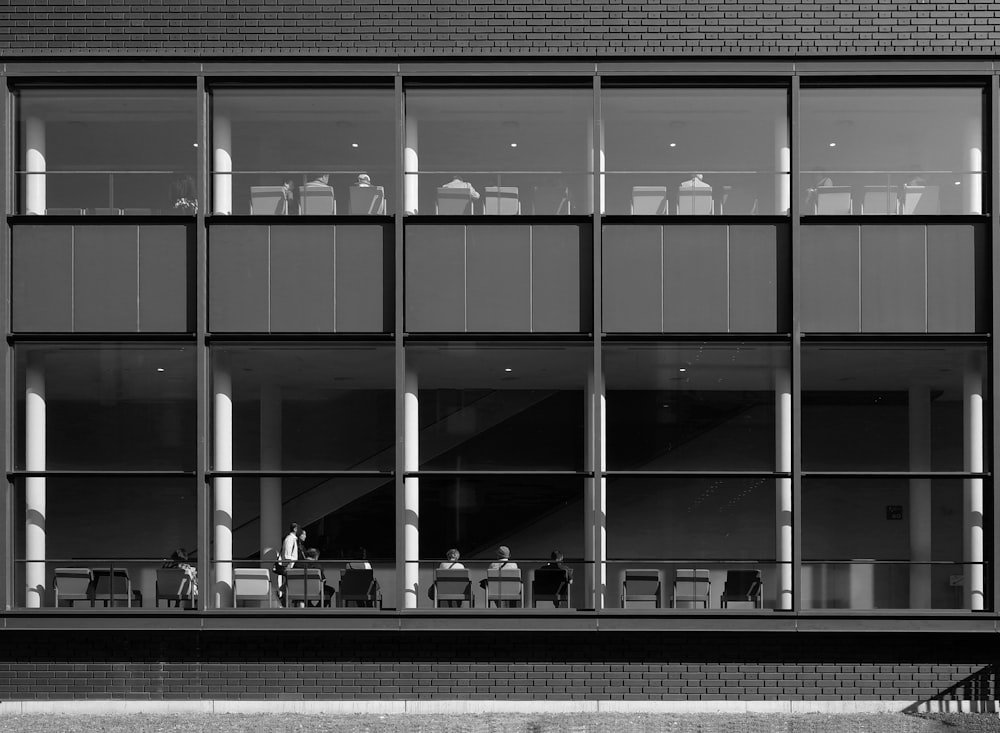 a black and white photo of people sitting at a table