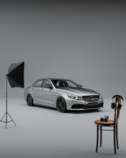Studio shot of a sleek luxury car with soft lighting and neutral background.
