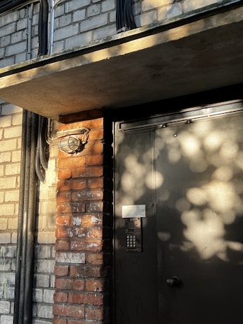 Close-up of a secure building entrance with advanced access control systems at dusk.