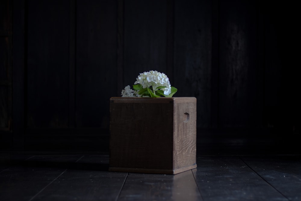 a wooden box with a bunch of flowers in it