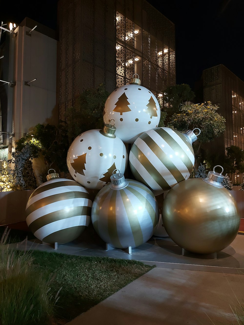 a pile of christmas ornaments sitting on top of a sidewalk