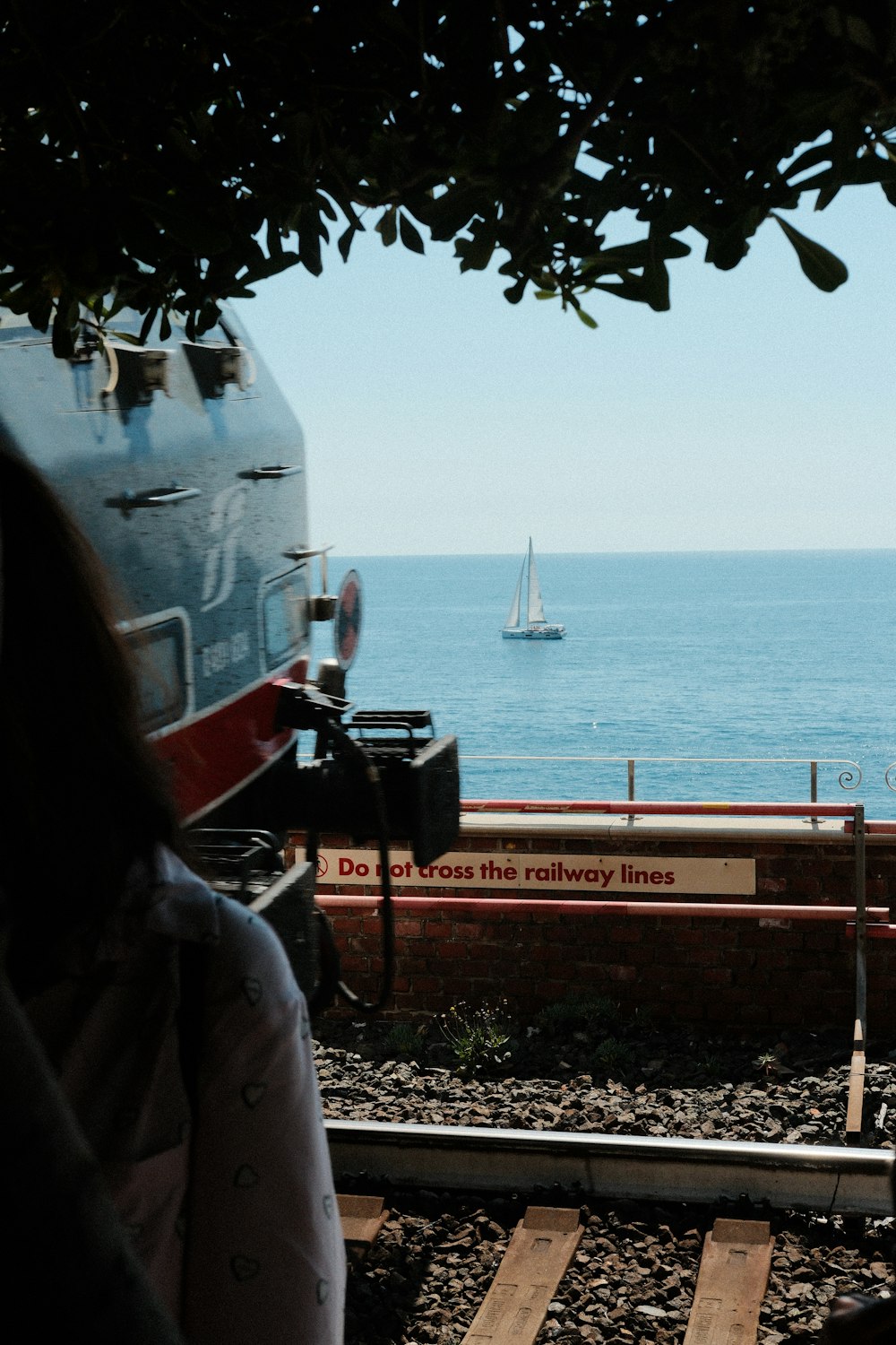 a view of the ocean from a train track