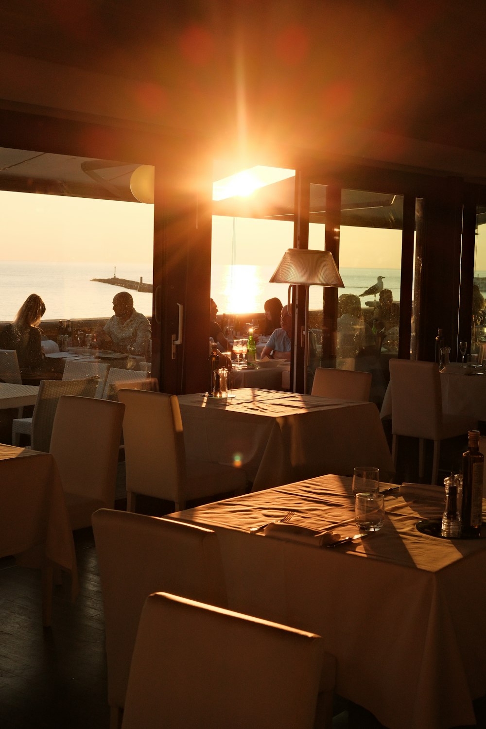 a restaurant with a view of the ocean at sunset