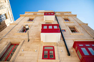 a tall building with red and white windows