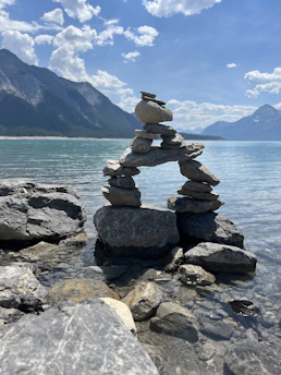 a stack of rocks sitting on top of a lake