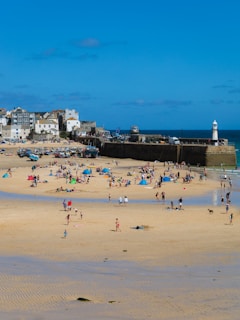 a group of people standing on top of a sandy beach