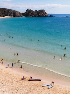 A scenic Australian beach with golden sand, turquoise waves, and surfers catching the morning swell.