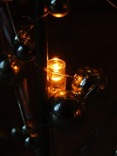 Close-up of vibrant 3D printed decorative items glowing under soft orange light