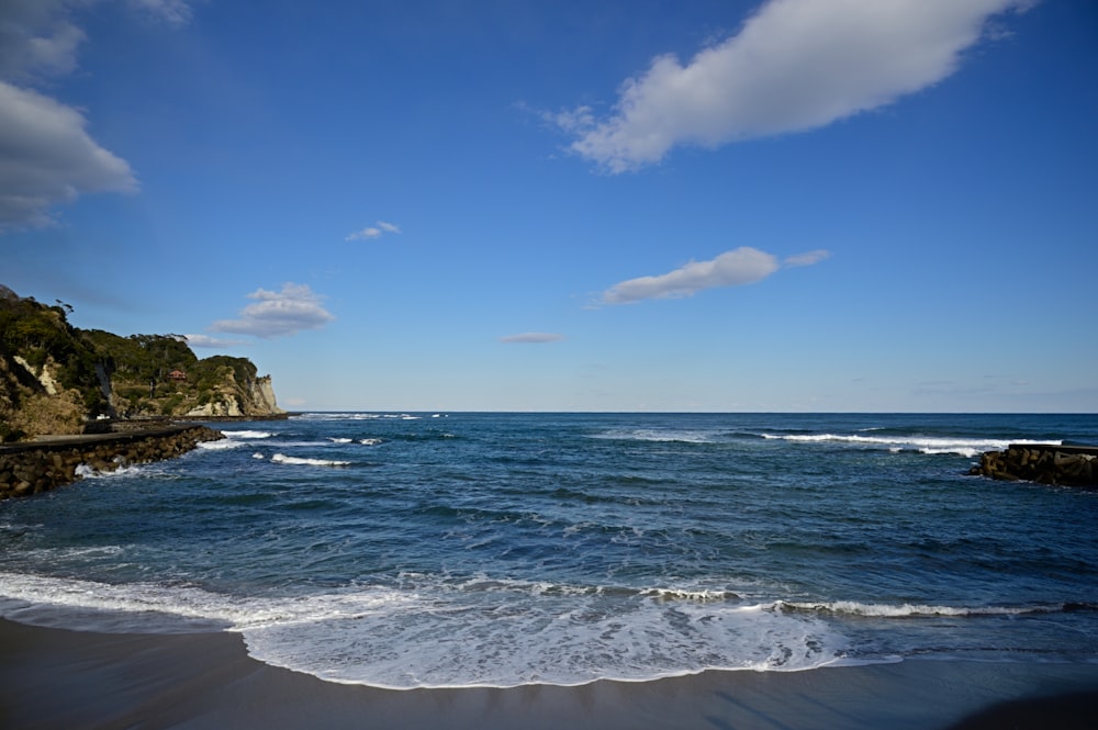 a body of water with waves coming in to shore