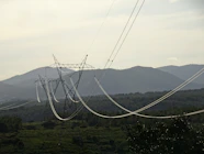 a view of a mountain range with power lines in the foreground