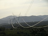 A rural Ontario landscape with Hydro One transmission towers stretching across rolling hills.
