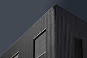 Exterior of a stylish commercial building in Pearland with sharp charcoal paint and clean lines.