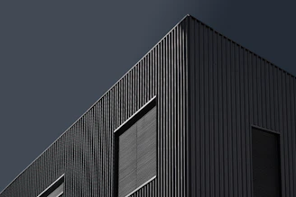 A sleek office building exterior freshly painted in dark obsidian tones.