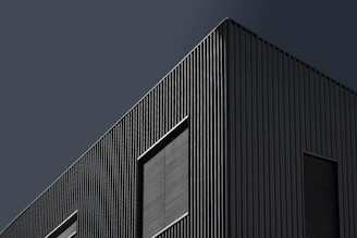 Sleek, minimalistic building facade with strong geometric shapes and muted colors.