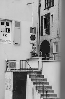 Photo of a man inspecting a vacation rental property exterior with a clipboard.