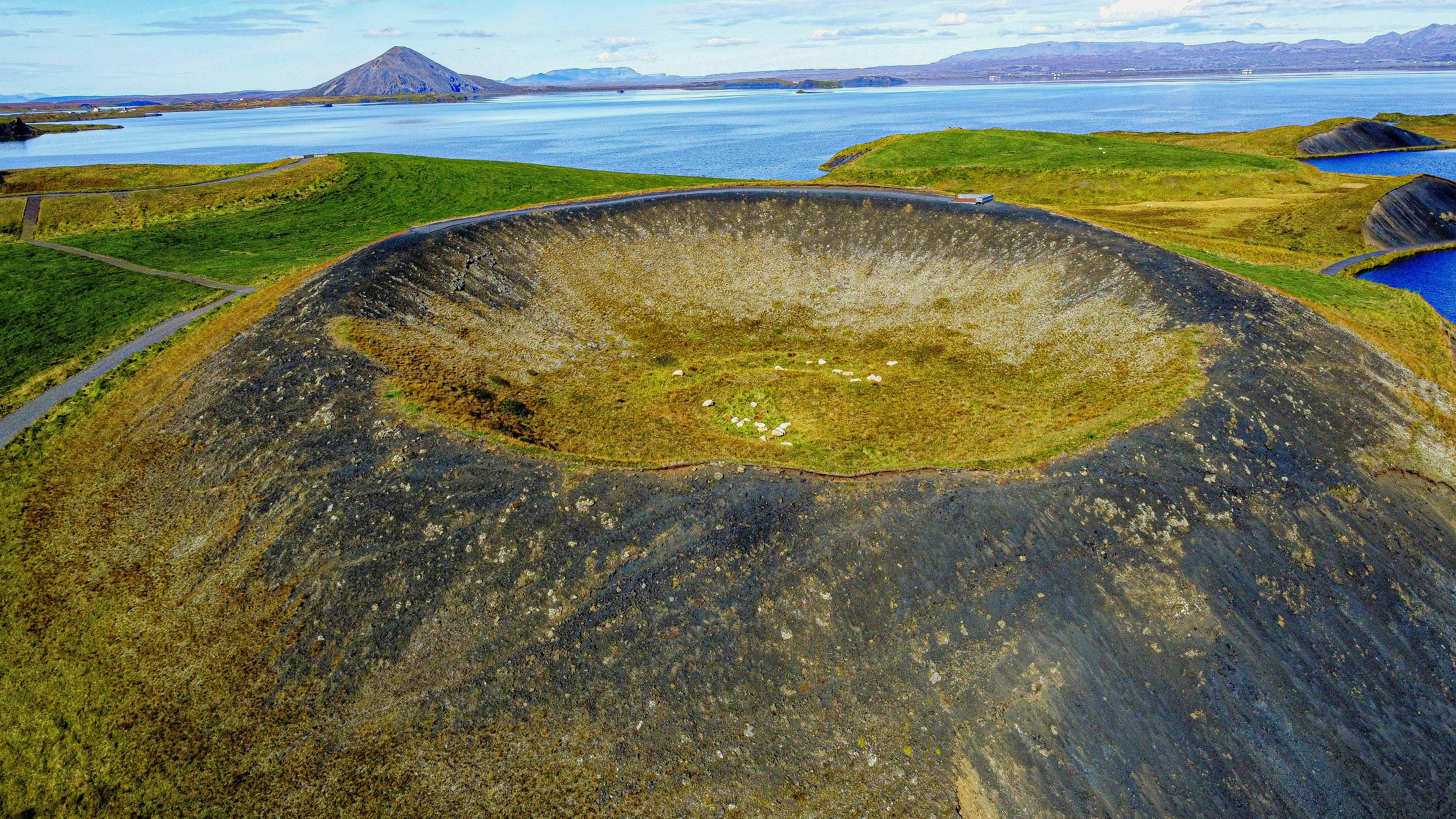 an aerial view of a large crater in the middle of a lake