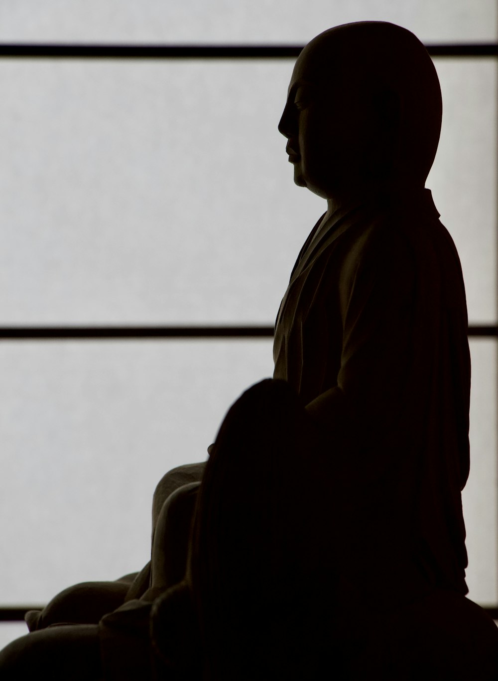 a statue of a person sitting in a chair