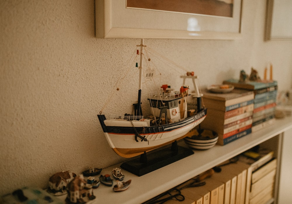 a model boat on a shelf in a room