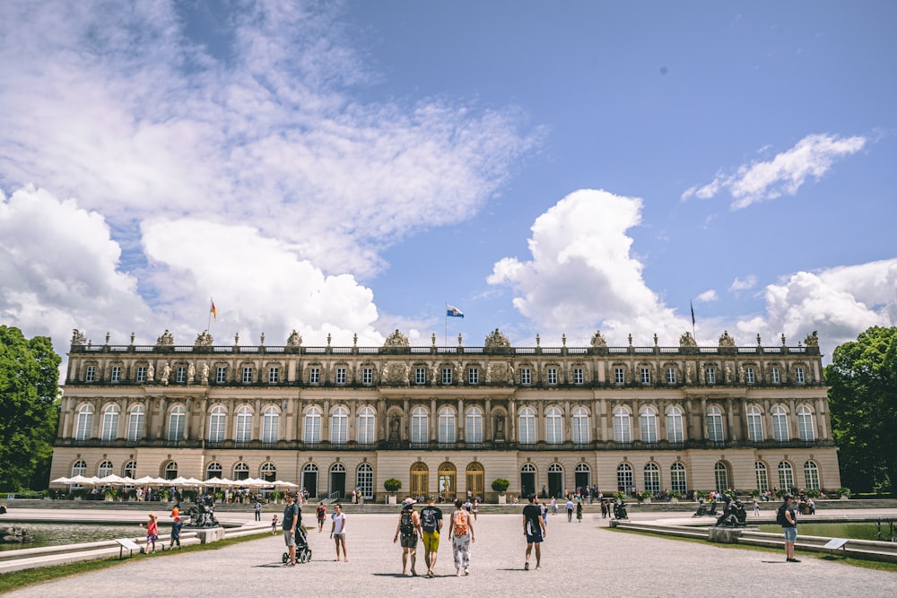 a group of people standing in front of a large building