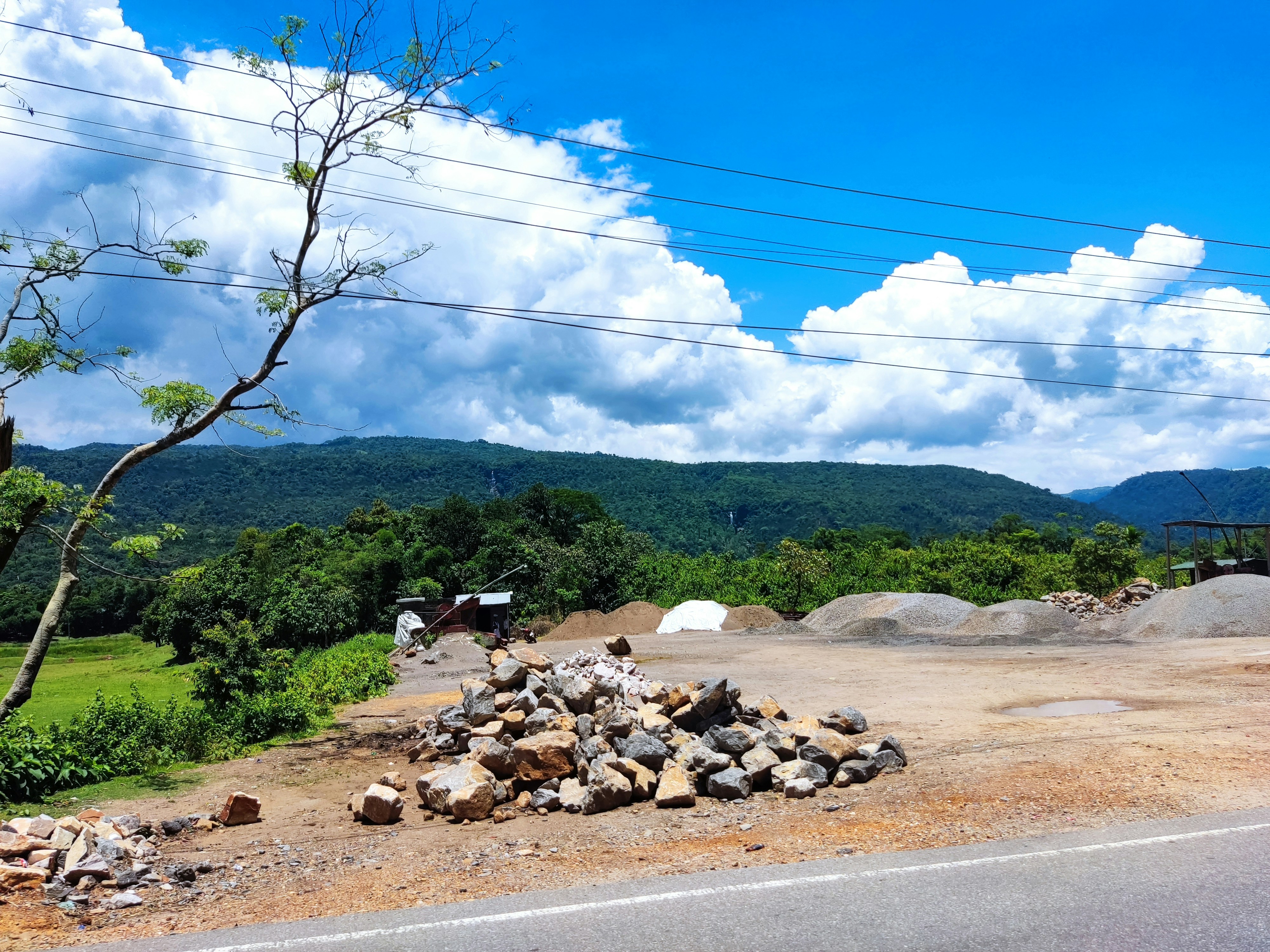A pile of rocks sitting on the side of a road photo – Free Jaflong ...