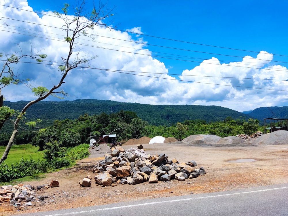 a pile of rocks sitting on the side of a road