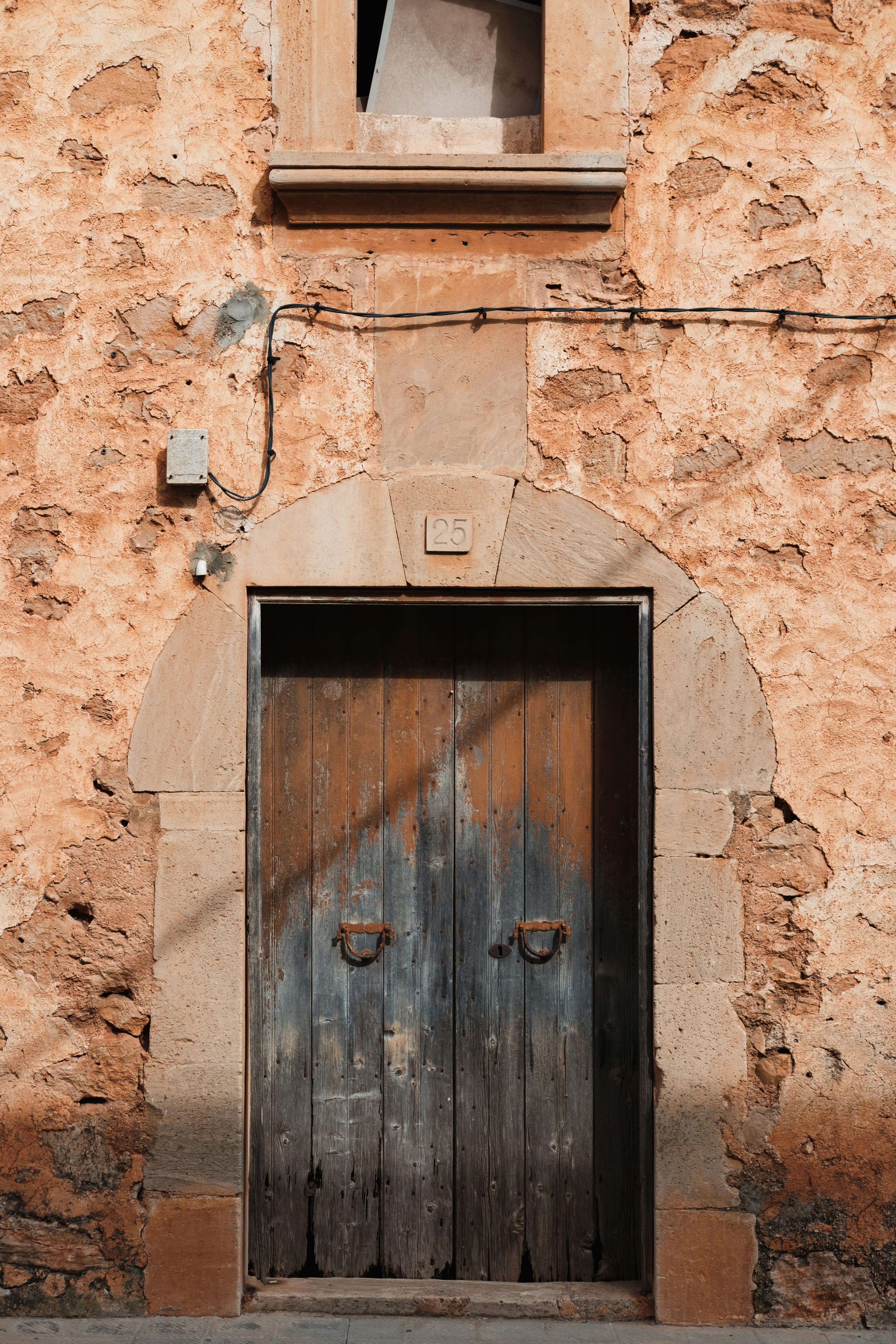 an old building with a wooden door and window