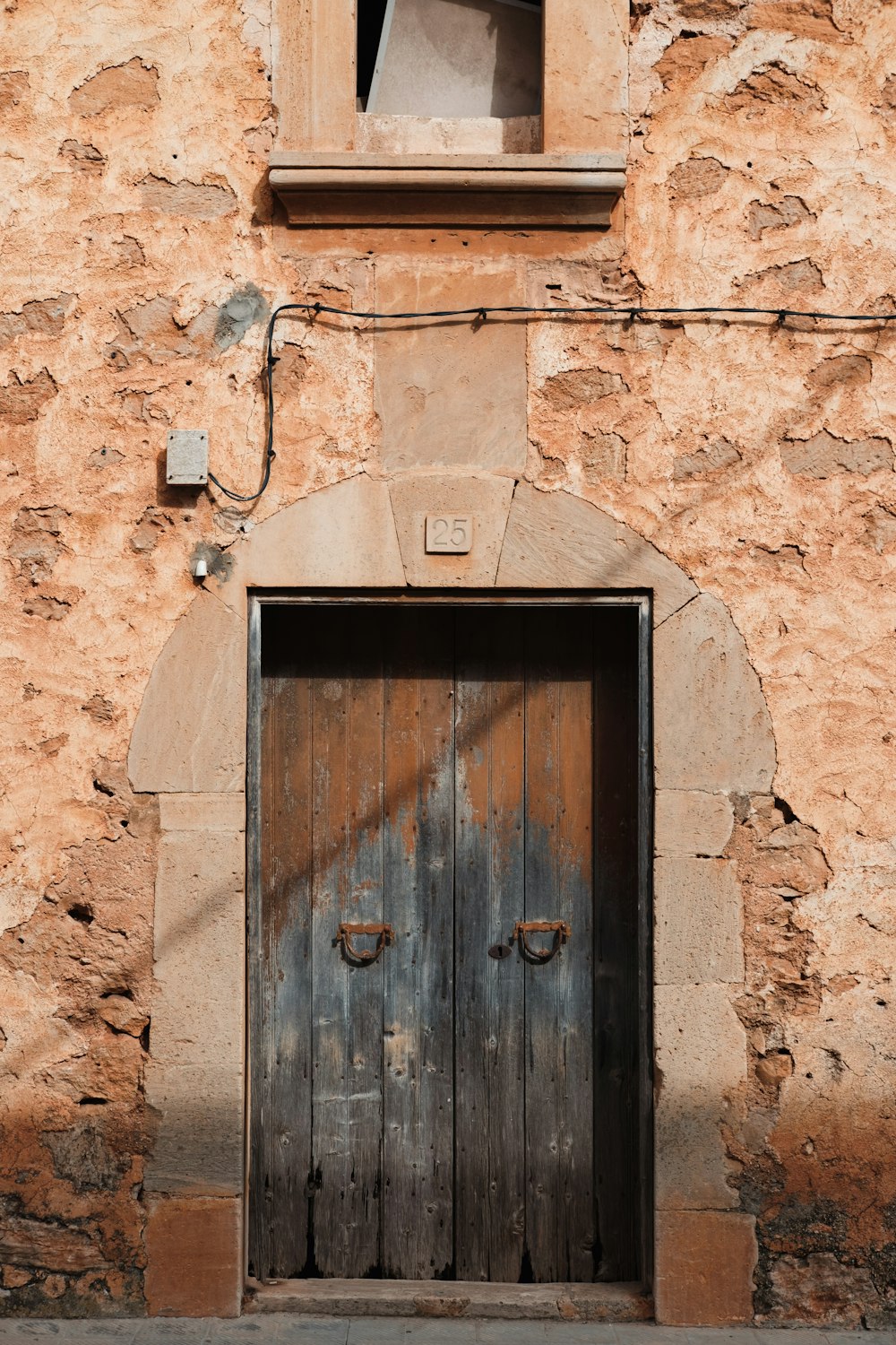 an old building with a wooden door and window