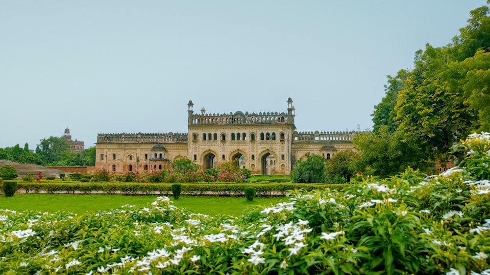 a large building surrounded by trees and flowers