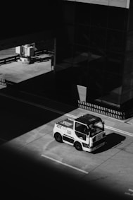 a black and white photo of a truck parked on the side of the road