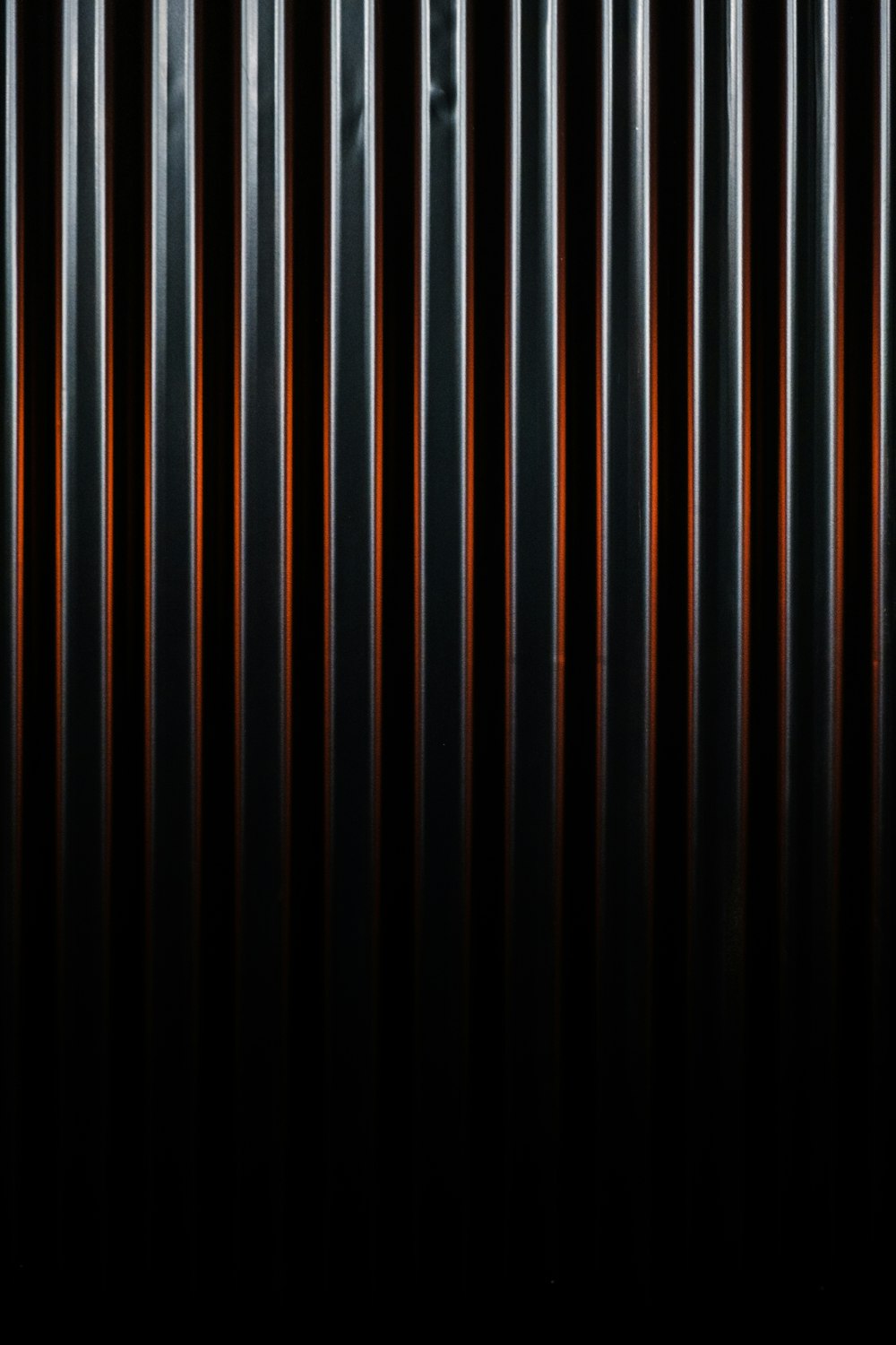 a black and orange striped wallpaper with a black background