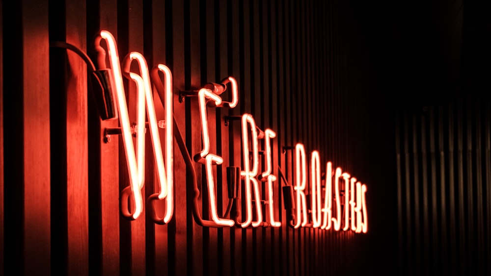 a red neon sign on the side of a building