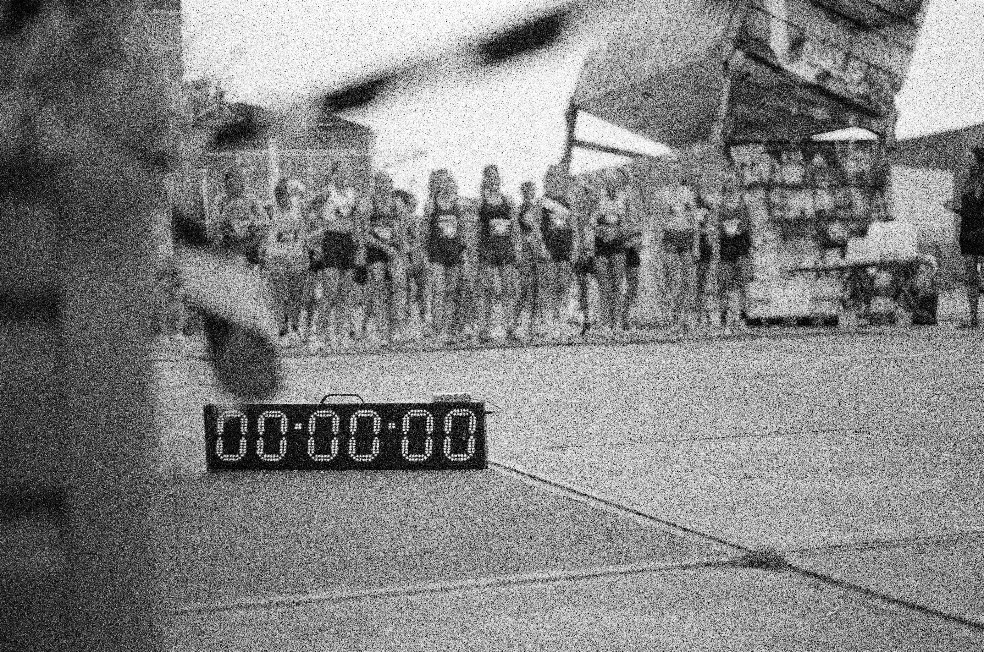 a black and white photo of a clock on the ground