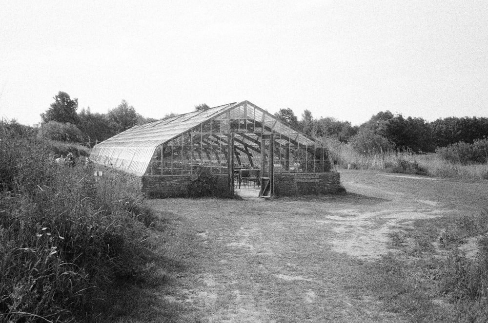 a black and white photo of a greenhouse