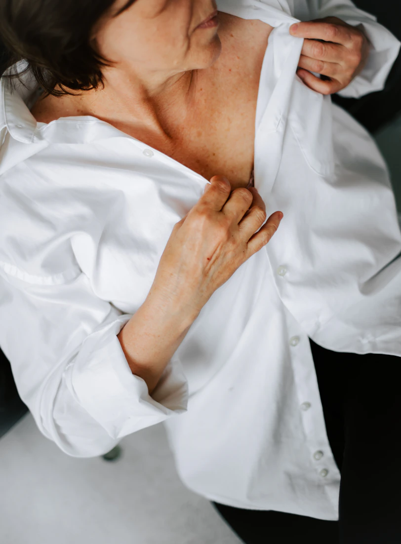 a woman in a white shirt and black pants