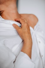A close-up of a man wearing a soft, trendy Wish Sand t-shirt in natural light.