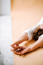 a woman laying on her back on a bed