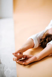 a woman laying on her back on a bed